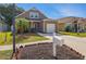A cozy two-story home with an attached garage and a well-kept lawn on a sunny day at 6616 Northhaven Ct, Riverview, FL 33578