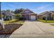 A neat two-story home with an attached garage and a long driveway in a suburban neighborhood at 6616 Northhaven Ct, Riverview, FL 33578
