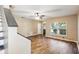 A living room featuring wood flooring, a ceiling fan, and a view of the staircase at 6616 Northhaven Ct, Riverview, FL 33578