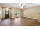The living room boasts wood floors, a large window, and a ceiling fan at 6616 Northhaven Ct, Riverview, FL 33578