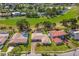 An aerial view of the home shows a pool, screened lanai, golf course views, and beautiful landscaping at 6790 Burning Tree Dr, Seminole, FL 33777