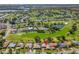 This aerial shot of the neighborhood shows lush golf course views and beautiful landscaping at 6790 Burning Tree Dr, Seminole, FL 33777