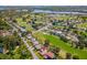 This aerial neighborhood view shows golf course frontage and lush tropical landscaping at 6790 Burning Tree Dr, Seminole, FL 33777