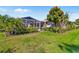 Well-maintained backyard with screened enclosure, lush landscaping, and a serene, private ambiance at 6790 Burning Tree Dr, Seminole, FL 33777