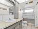 Bathroom with a shower, toilet, neutral countertop and tile flooring at 6790 Burning Tree Dr, Seminole, FL 33777