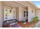 Inviting front entrance with decorated white door, beautiful brick flooring, and decorative lattice at 6790 Burning Tree Dr, Seminole, FL 33777