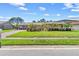 Charming single-story home with well-manicured lawn, mature landscaping, and inviting curb appeal under a sunny blue sky at 6790 Burning Tree Dr, Seminole, FL 33777