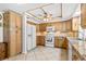 Bright kitchen featuring wood cabinets, granite counters, and modern appliances with tile flooring at 6790 Burning Tree Dr, Seminole, FL 33777