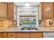 Bright kitchen featuring granite counters and sink with a view of the pool at 6790 Burning Tree Dr, Seminole, FL 33777