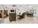 Open living room with tiled floors, comfortable seating, and easy access to the dining area at 6790 Burning Tree Dr, Seminole, FL 33777