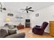 Cozy living room with a plush couch, ceiling fan and window at 6790 Burning Tree Dr, Seminole, FL 33777