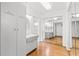 Bright main bathroom with wood floors, mirrored closets, and a vanity sink at 6790 Burning Tree Dr, Seminole, FL 33777