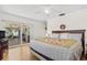 Bright main bedroom with wood floors, large windows, and access to the outdoor patio at 6790 Burning Tree Dr, Seminole, FL 33777