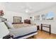 Spacious main bedroom with wood floors, natural light, and comfortable furnishings at 6790 Burning Tree Dr, Seminole, FL 33777