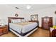 Comfortable main bedroom with wood floors, ceiling fan, and classic wooden furniture at 6790 Burning Tree Dr, Seminole, FL 33777
