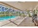 Enclosed patio area with a pool, outdoor seating and barbeque at 6790 Burning Tree Dr, Seminole, FL 33777