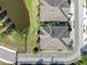 Overhead view of the home showing the roof, proximity to parking, pond and landscaping at 6851 Breezy Palm Dr, Riverview, FL 33578