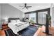 Bedroom with black accent wall, work area, hardwood floors and natural lighting at 6851 Breezy Palm Dr, Riverview, FL 33578