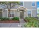 Charming front entrance with a well-kept yard, inviting pathway, and freshly painted olive colored door at 6851 Breezy Palm Dr, Riverview, FL 33578