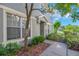 View of the front yard and entry, featuring a well-manicured lawn and mature landscaping at 6851 Breezy Palm Dr, Riverview, FL 33578
