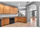 Kitchen featuring wooden cabinets, tile floors, stainless sink and black appliances at 6851 Breezy Palm Dr, Riverview, FL 33578