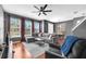 Open living space featuring hardwood floors, cozy seating, large windows and staircase at 6851 Breezy Palm Dr, Riverview, FL 33578