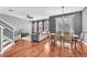 View of the combined living and dining areas with hardwood floors and lots of natural light at 6851 Breezy Palm Dr, Riverview, FL 33578
