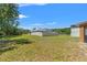 Spacious backyard with a privacy fence, lush lawn, and mature trees at 7102 W Creek Dr, Tampa, FL 33615