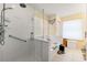 Modern bathroom with a glass-enclosed shower, soaking tub, and a neutral color palette at 7102 W Creek Dr, Tampa, FL 33615