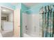 Bright bathroom featuring a white tub/shower combo and colorful shower curtain at 7102 W Creek Dr, Tampa, FL 33615
