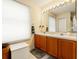 Bright bathroom featuring a double sink vanity, a large mirror, and neutral decor at 7102 W Creek Dr, Tampa, FL 33615