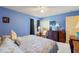Cozy bedroom with blue walls and a floral bedspread at 7102 W Creek Dr, Tampa, FL 33615