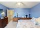 Comfortable bedroom with blue walls and a floral bedspread at 7102 W Creek Dr, Tampa, FL 33615