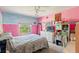 Bright pink bedroom with a large window, white dresser, and comfortable bed at 7102 W Creek Dr, Tampa, FL 33615