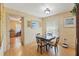 Cozy dining area with a glass-top table and wood flooring, perfect for Gathering meals at 7102 W Creek Dr, Tampa, FL 33615