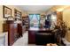 Inviting home office with hardwood furniture, shelving, and natural light at 7102 W Creek Dr, Tampa, FL 33615