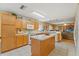 Functional kitchen with a center island, bright lighting, and easy access to the living area at 7102 W Creek Dr, Tampa, FL 33615