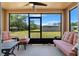 Inviting screened porch with comfortable seating and a view of the backyard at 7102 W Creek Dr, Tampa, FL 33615
