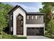 Stunning modern farmhouse featuring black siding, stucco accents, large windows, and a two-car garage at 812 W Braddock St, Tampa, FL 33603