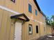 Side view of the new construction featuring horizontal siding, modern windows, and covered entry at 812 W Braddock St, Tampa, FL 33603