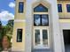 Close-up of the front entrance featuring double doors, tall windows, and modern stone columns at 812 W Braddock St, Tampa, FL 33603