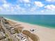 Breathtaking aerial view of a beach with turquoise water and vacation properties at 844 67Th S St, South Pasadena, FL 33707
