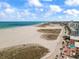 Aerial view showcasing a sunny beach, resorts, and a picturesque boardwalk at 844 67Th S St, South Pasadena, FL 33707