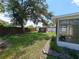 A shot of the backyard featuring a shed, screened in porch, with a well maintained lawn, and a blue sky at 844 67Th S St, South Pasadena, FL 33707