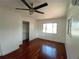 Bedroom with hardwood floors, a ceiling fan, closet, and a window at 844 67Th S St, South Pasadena, FL 33707