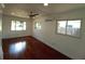 Sunlit bedroom with hardwood floors, modern ceiling fan, and multiple windows at 844 67Th S St, South Pasadena, FL 33707