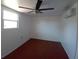 Bright bedroom features modern ceiling fan, mini-split air conditioner, and window at 844 67Th S St, South Pasadena, FL 33707