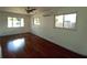Bedroom with hardwood floors, ceiling fan, and natural light from the many windows at 844 67Th S St, South Pasadena, FL 33707