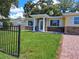 Charming home featuring a well-kept lawn and stone accents under the windows, and a gated fence at 844 67Th S St, South Pasadena, FL 33707