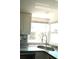 Bright kitchen with granite countertops, stainless steel sink, and tiled backsplash at 844 67Th S St, South Pasadena, FL 33707